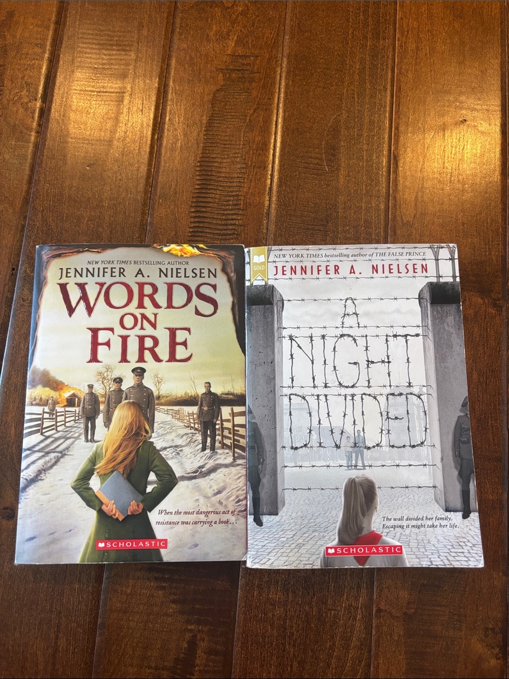 Paperback Books — Words on Fire & A Night Divided by Jennifer A. Nielsen